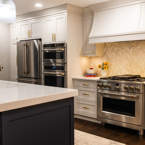 White cabinets in a kitchen, fridge, oven